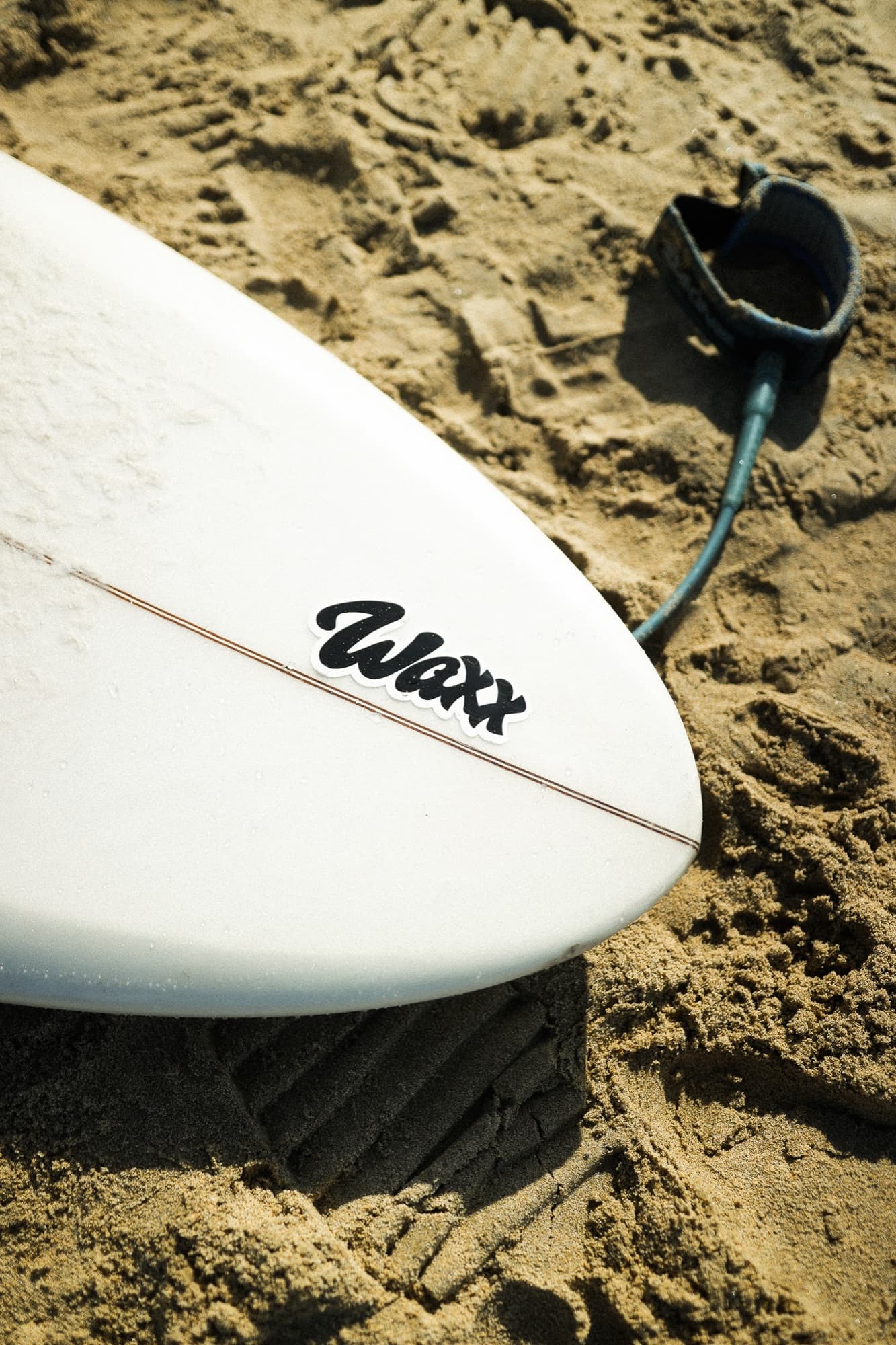 Waxx board in the sand, California coast