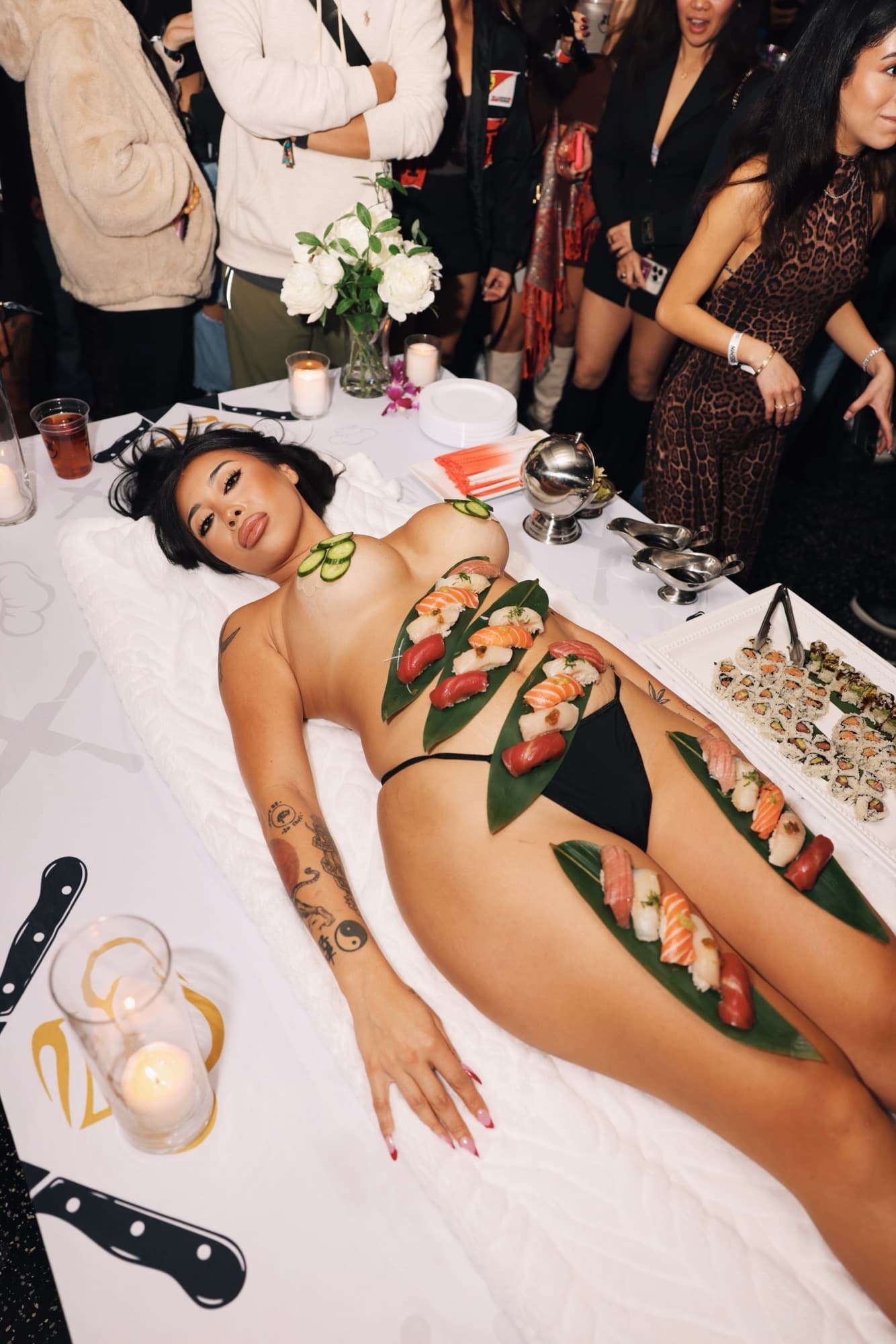 The group sharing a sushi spread, a Waxx Snaxx pack on the table